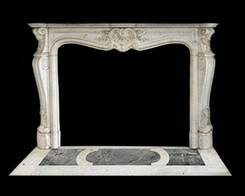 A late 19th-century Louis XV Revival fireplace and hearth carved in Carrara marble, featuring a serpentine frieze and central cartouche. 